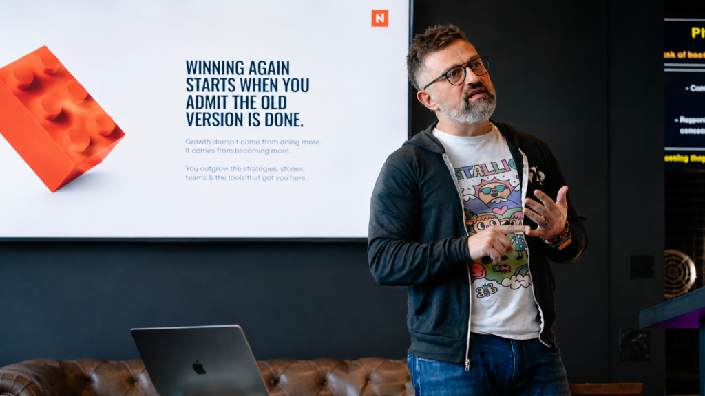 George Arabian teaching marketing fundamentals to a room of marketers during a growth accelerator session