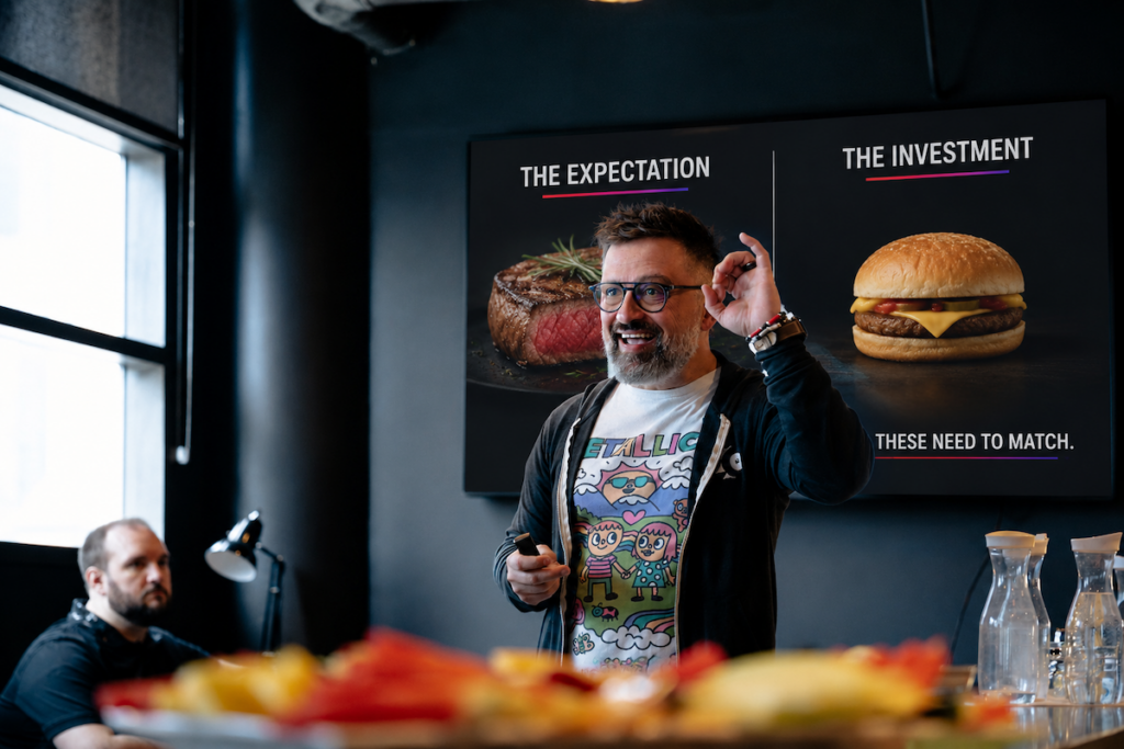George Arabian explaining how much you should spend on marketing during a live talk