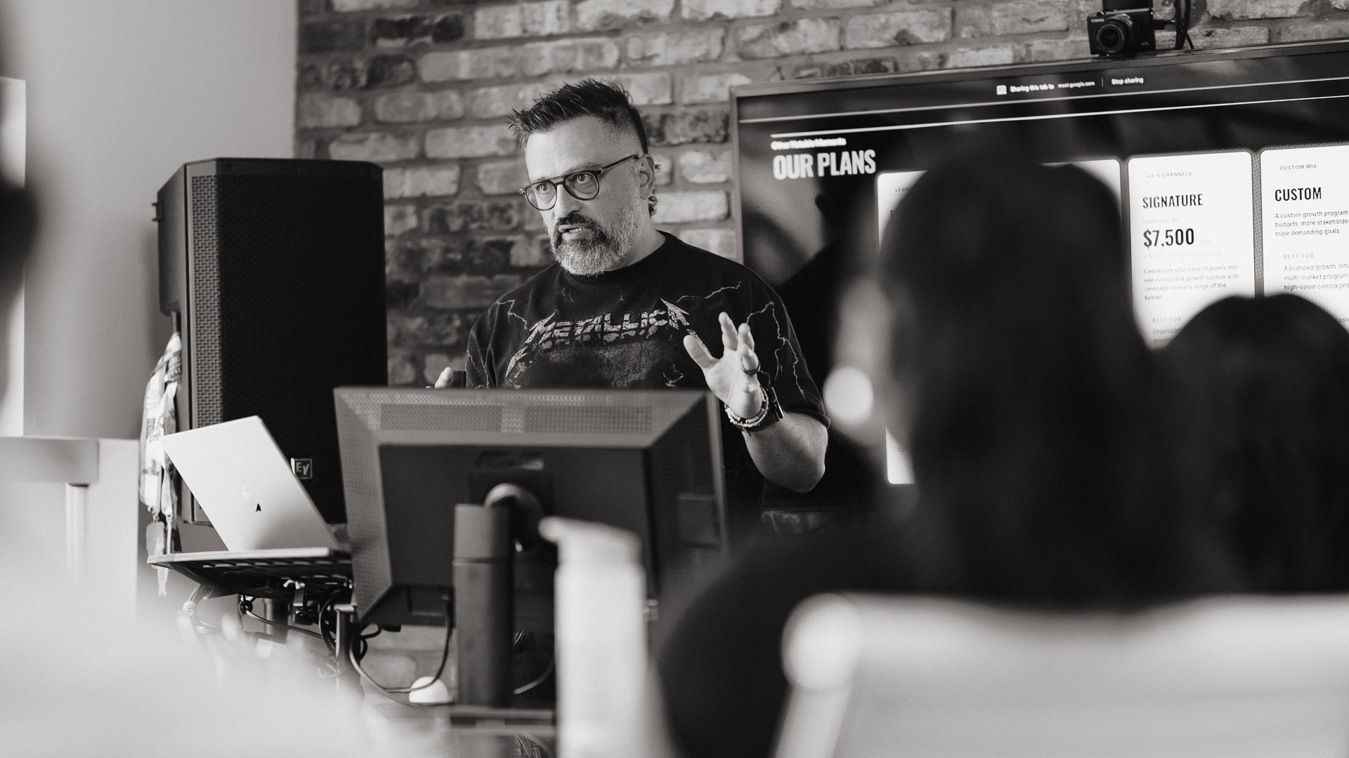 CEO explaining why his Toronto web design company is trusted by business leaders during a team meeting