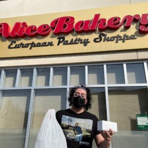 Michael outside of Alice Bakery showing his local store bought goods