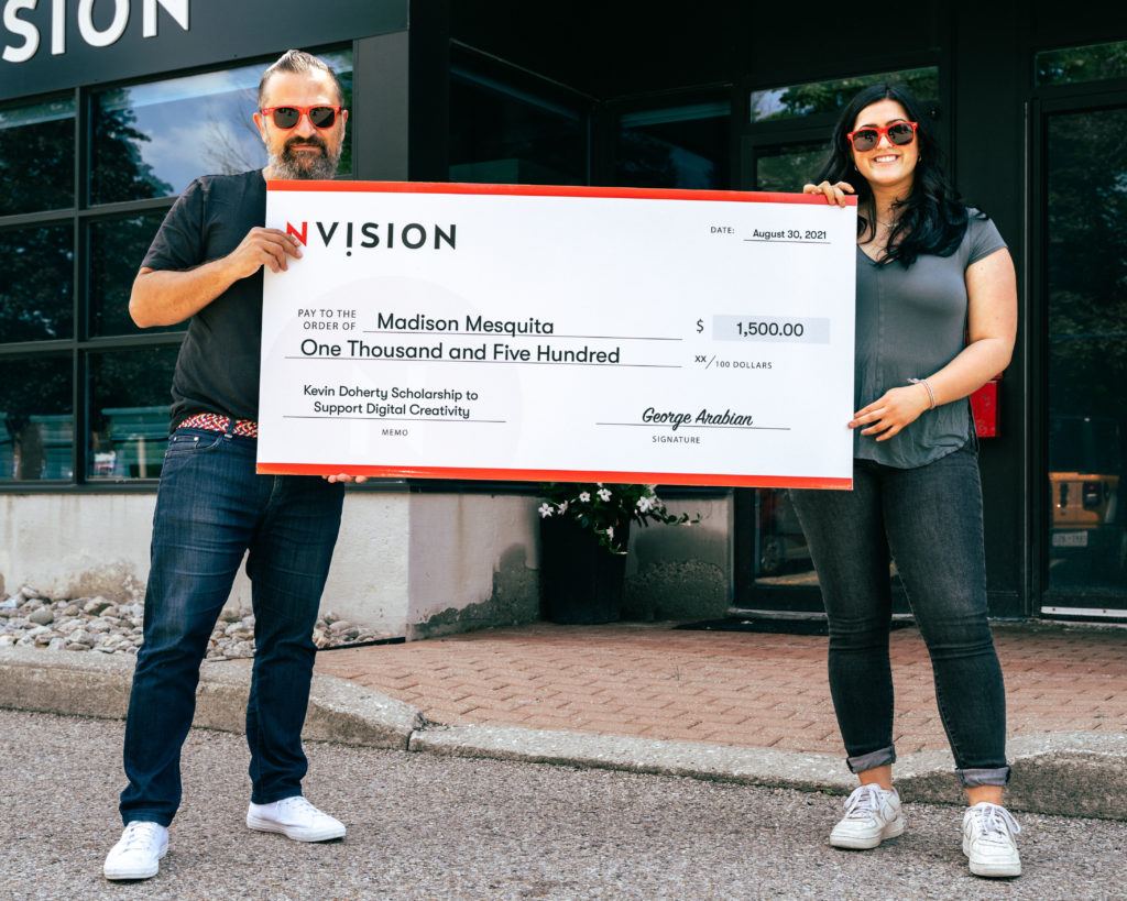 George Arabian and 2021 Recipient Madison Mesquita, at NVISION Headquarters holding a large Cheque.